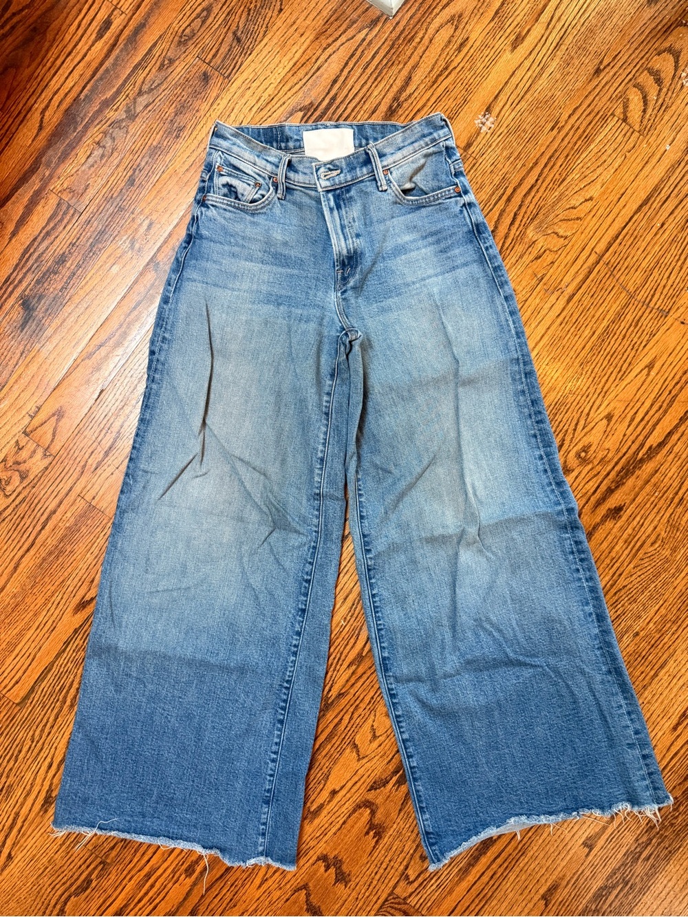 MOTHER Wide Leg Flare Jeans in Light Blue to Medium Blue Fade